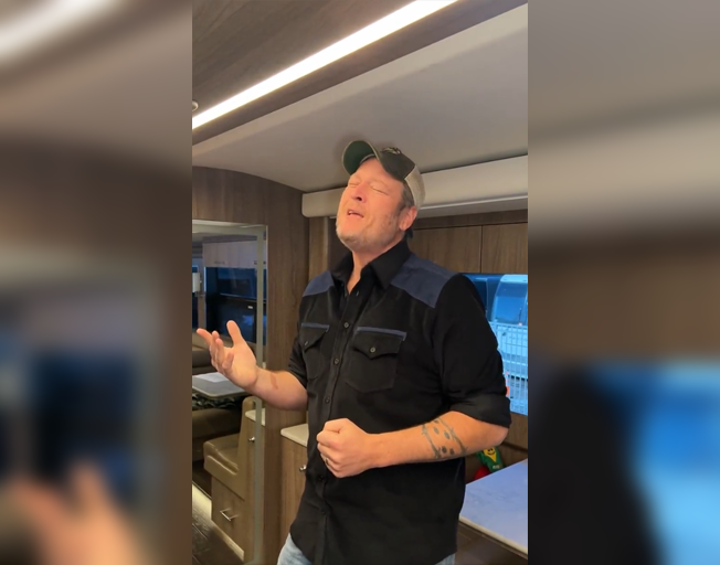 Blake Shelton lip syncing to a song on his bus