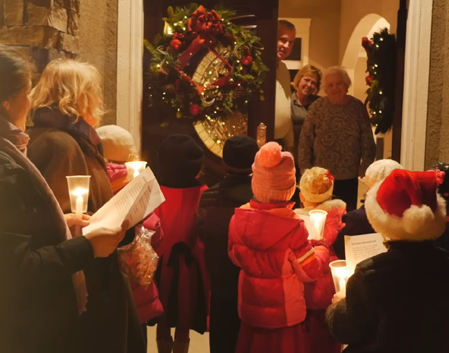 People Christmas Caroling at the front door of a house