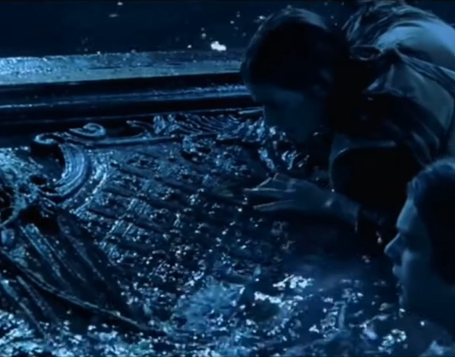 Screen shot from Titanic with Leonardo DiCaprio and Kate Winslet in the water with a door floating